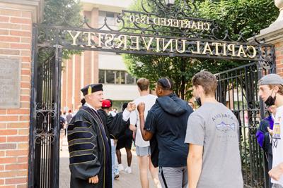 President Kaufman Welcoming Students Through The Gate